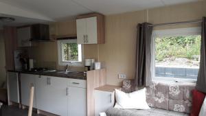 a small kitchen with a couch and a window at Ferienhaus 2 Chalet in Ahrbrück