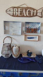a table with plates and a fish sign on a wall at Amanecer en Cristal in Cartagena