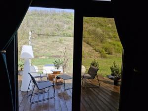 a view of a porch with chairs and a table at Forest Studio Corunca in Corunca