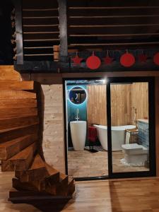 a bathroom with a bath tub and a mirror at Forest Studio Corunca in Corunca