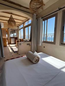 a bedroom with a bed with a towel on it at SurfAppart Morocco in Tamraght Ouzdar