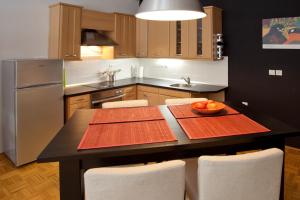 a kitchen with a table with a bowl of fruit on it at Apartment REZIDENCA GOGA in Novo Mesto