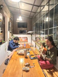 two people sitting at a table in a restaurant at Mellow Fellow Hostel Darjeeling in Darjeeling +61 photos