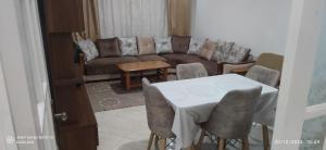 een woonkamer met een tafel en een bank bij appartement T3 équipe in Matriouene