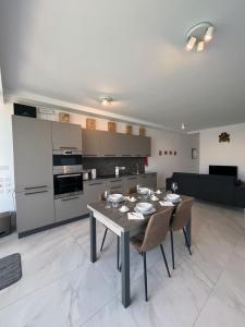 a kitchen and dining room with a table and chairs at Bay Seafront Apartment in Marsaskala
