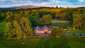 an aerial view of a house on a hill at Loch Lomond Finnich Cottages in Drymen