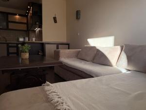 a living room with a couch and a table at Home by the Sea MAIN STREET and POOL in Burgas