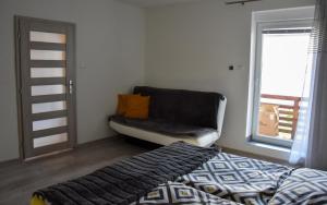 A bed or beds in a room at Apartmán u Braňa