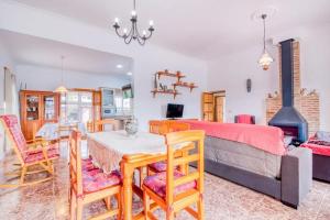 a bedroom with a bed and a table and chairs at Family Villa in Benifayó with Year-Round Private Pool in Benifayó