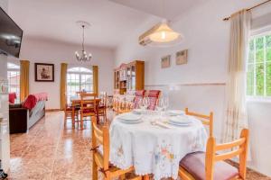 a dining room and living room with a table and chairs at Family Villa in Benifayó with Year-Round Private Pool in Benifayó +24 photos