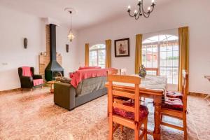 a bedroom with a bed and a table and chairs at Family Villa in Benifayó with Year-Round Private Pool in Benifayó