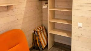 a walk in closet with an orange chair and a purse at VacationClub - Madamaku VacationHome 29 in Sianozety