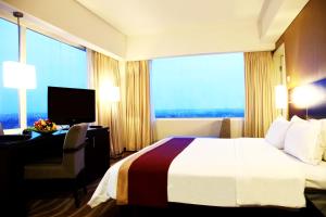 Java Paragon Hotel & Residences tesisinde bir odada yatak veya yataklar