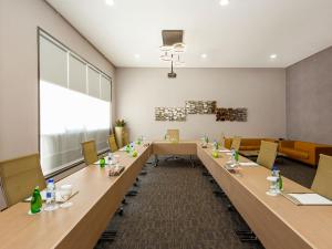 a large conference room with a long table and chairs at Flora Al Barsha Hotel At The Mall in Dubai