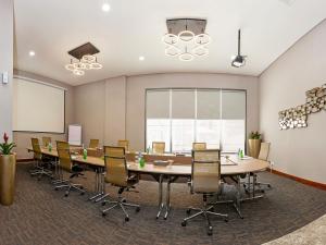 a conference room with a large table and chairs at Flora Al Barsha Hotel At The Mall in Dubai