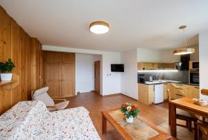 a living room with a couch and a table at Aparthotel Teddy Kvilda in Kvilda