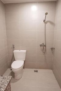 a bathroom with a toilet and a shower at The Rustic Home - Nguyên căn in Ho Chi Minh City +17 photos