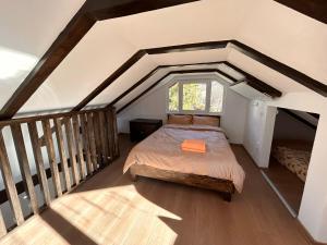 a bedroom with a bed in a attic at Casa Mihai in Bîsca Rozilei