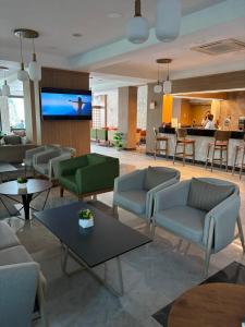 a lobby with couches and tables and a bar at Sırma Hotel - All Inclusive in Side