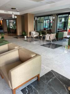 a lobby with a couch and tables and chairs at Sırma Hotel - All Inclusive in Side +55 photos