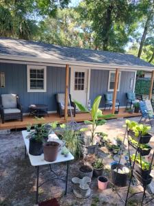 a small house with plants on a patio at Tiny home barn style in backyard with Animals in Orlando