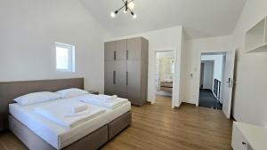 a bedroom with a large white bed in a room at Apartments Tota in Starigrad-Paklenica