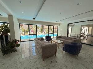 a large living room with couches and a pool at SA Apartments! Mahmutlar, 300m to the Beach in Alanya