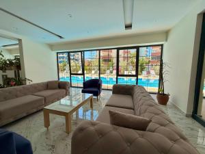 a large living room with couches and a pool at SA Apartments! Mahmutlar, 300m to the Beach in Alanya
