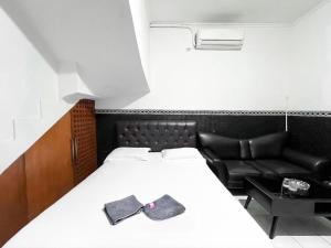 a bedroom with a bed with two ties on it at Modom Residence in Jakarta