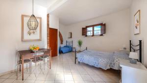 a bedroom with a bed and a table and a desk at Podere Santo Signoretto in San Vincenzo