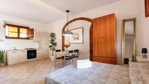 a kitchen and living room with a table in a room at Podere Santo Signoretto in San Vincenzo +24 photos