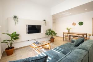 a living room with a couch and a table at Stylish 3BR Apt w Balcony 5 min Walk from Beach with Shelter by Sea N' Rent in Tel Aviv