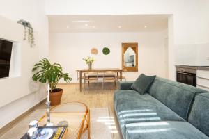 a living room with a couch and a table at Stylish 3BR Apt w Balcony 5 min Walk from Beach with Shelter by Sea N' Rent in Tel Aviv +35 photos