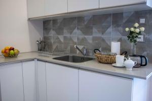a kitchen with a sink and a counter top at The Skies by YourHost Nairobi in Nairobi