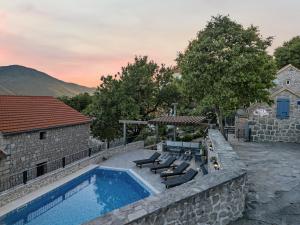 a backyard with a swimming pool and a house at Holiday Home Sonja - Makarska Exklusiv in Vrgorac