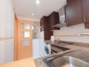 a kitchen with a sink and a washing machine at Ayf playa dorada 1ª linea de mar in El Borseral