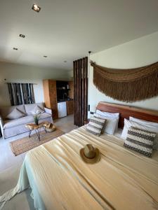 a bedroom with a large bed and a couch at MOLA PAPAYA STUDIOS in Mola Kalyva
