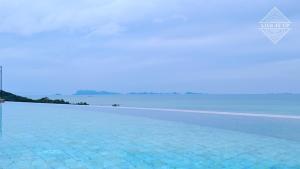 a rendering of a swimming pool with the ocean in the background at Santi Pura Villas in Koh Samui 