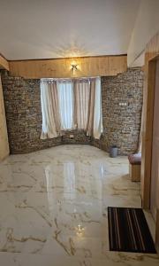 a room with a marble floor and a window at Shree Guru Home Stay in Jāmb