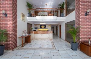 a lobby of a hotel with a brick wall at Hotel Pravasa Stay in Vadodara +91 photos
