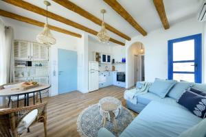 a living room with a blue couch and a table at Authentic Beachfront Apartment by Sea N' Rent in Nahariyya
