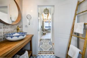 a bathroom with a sink and a mirror at Authentic Beachfront Apartment by Sea N' Rent in Nahariyya +27 photos
