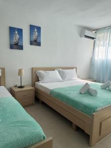 a bedroom with two beds in a room at Emy's Rooms in Himare