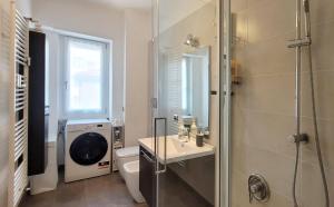 a bathroom with a shower and a sink and a toilet at Comfortable apartment in the heart of Lecco in Lecco