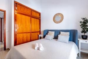 a bedroom with a bed with two towels on it at Playa de San Juan - Santa Martha duplex in Playa de San Juan