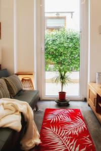 a living room with a couch and a red rug at Wabi Sabi suite in San Benedetto del Tronto