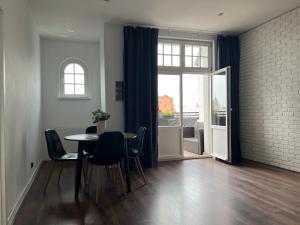 a dining room with a table and chairs and a window at Exclusive Apartment in Grudziądz