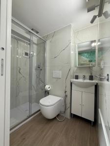 a bathroom with a shower and a toilet and a sink at Corte Verde 5 in Bari +29 photos