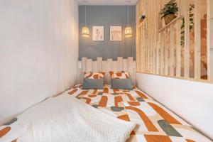 a bedroom with a bed and two pillows on it at Petit cocon provençal à 2mn d'Arles in Fourques
