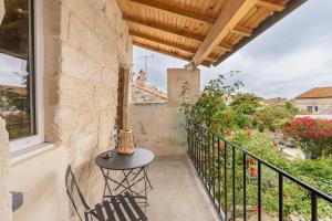 a patio with a table and chairs on a balcony at Petit cocon provençal à 2mn d'Arles in Fourques